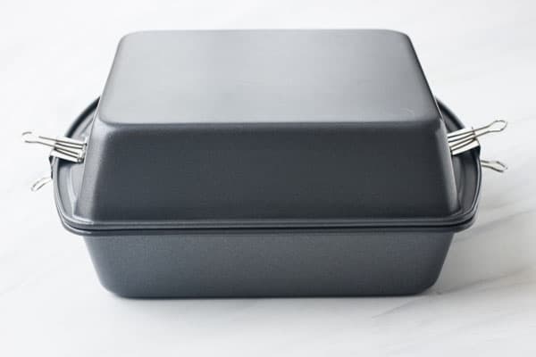 Two square metal pans stacked on top of each other.