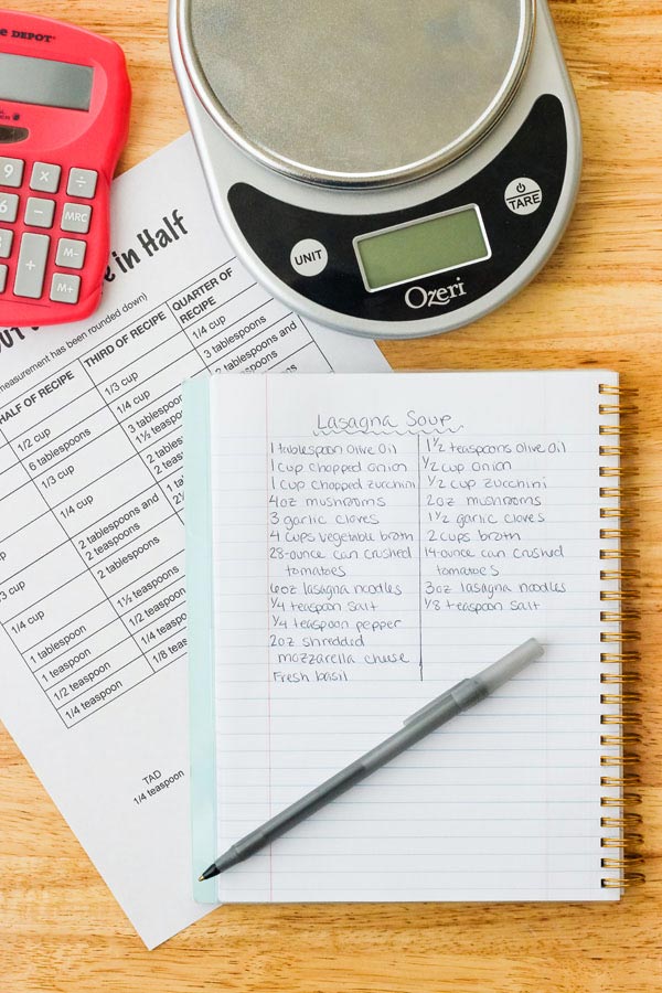 Notebook with pen and calculator on a table.