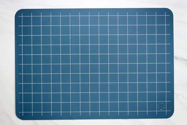 Large blue baking mat flat on table.