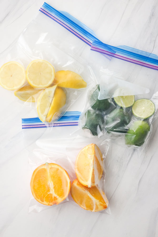 Plastic freezer bags with lemon, orange, and lime wedges and halves.