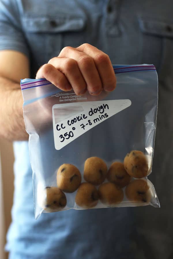 Man holding bag of frozen cookie dough balls.