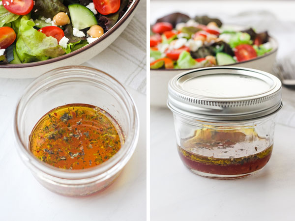 Small mason jar with salad dressing with a green salad in the background.