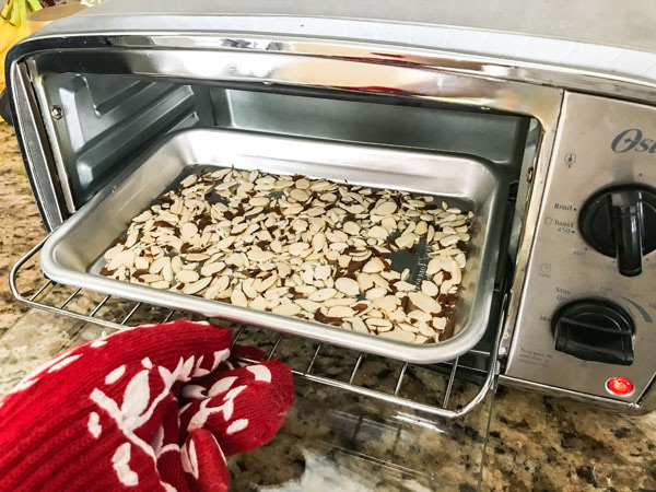 Toasted sliced almonds in a toaster oven.