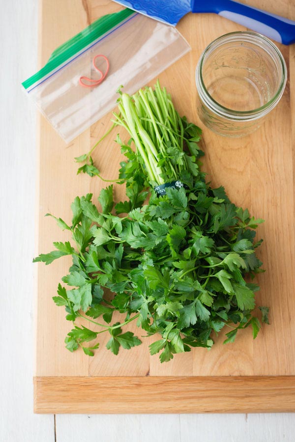 A bunch of fresh parsley on a cutting board