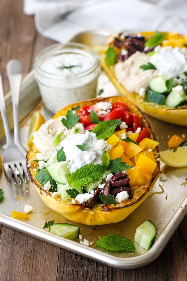 Stuffed spaghetti squash on a baking sheet.