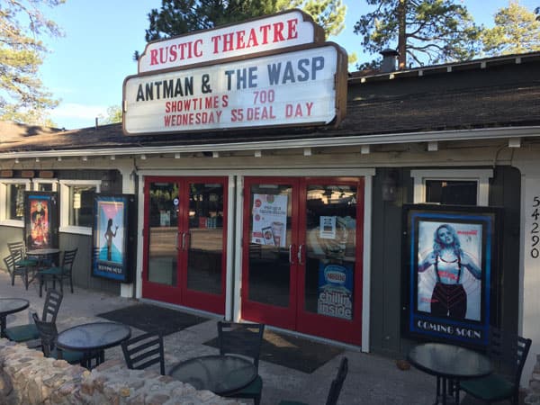 Small theater with trees behind it.