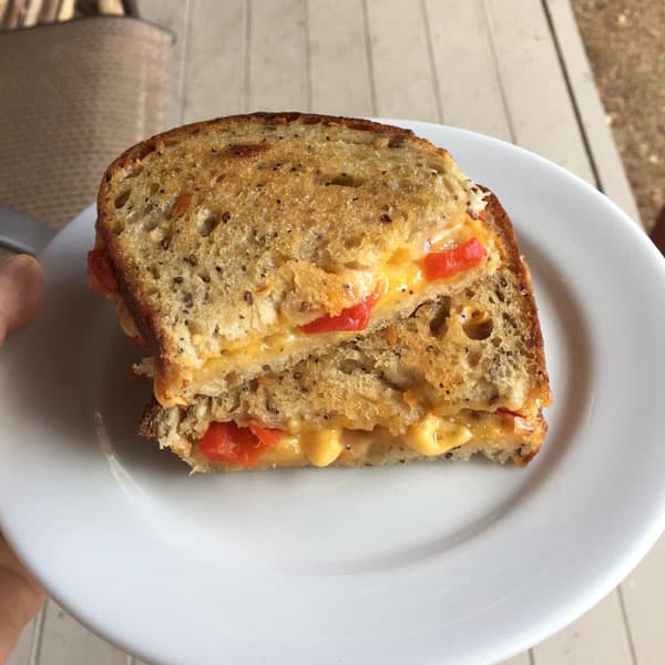 Crispy toaster oven grilled cheese with roasted red pepper on a white plate.