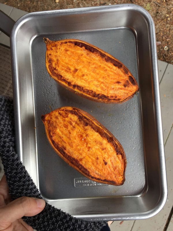 Baked sweet potato halves on an 1/8 sheet pan.