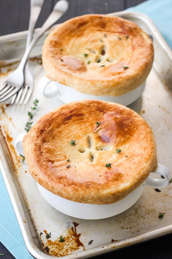 Individual pot pies on a rimmed sheet pan.