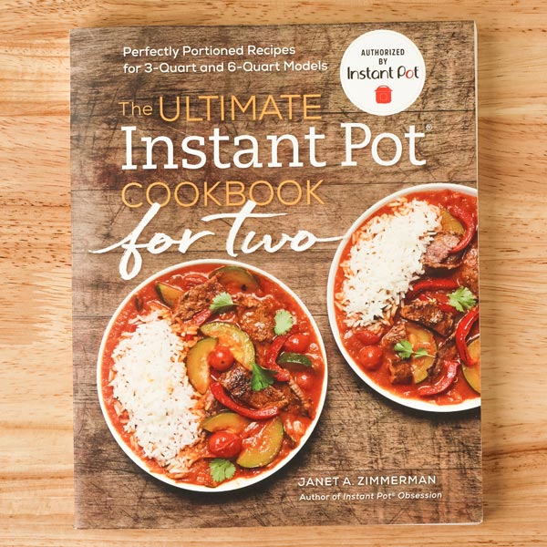 The Ultimate Instant Pot Cookbook For Two book cover featuring two bowls of rice and stew.