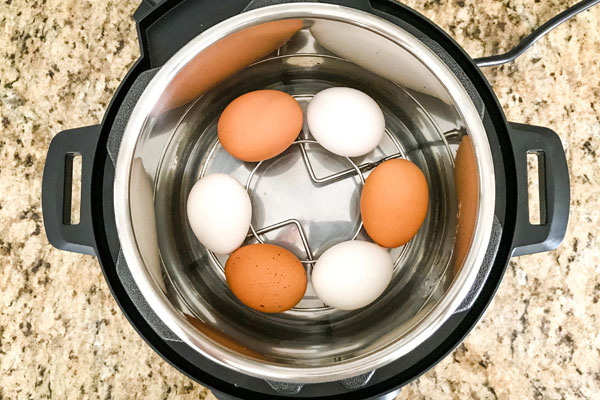 Eggs on a metal rack inside an instant pot mini.