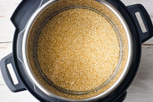 Quinoa and water inside a 3 quart Instant Pot.