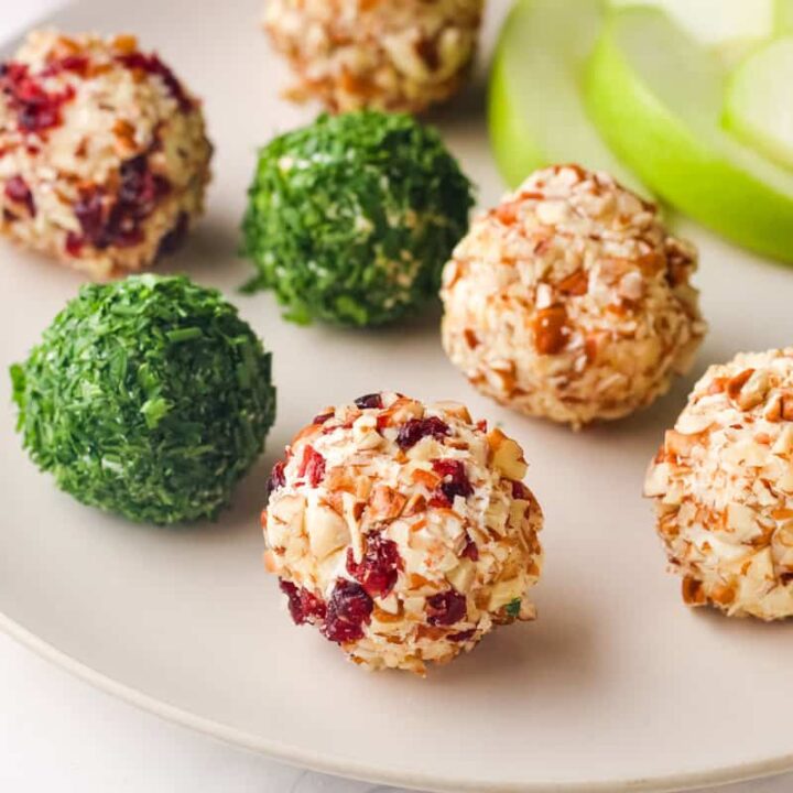 Plate of individual cheese balls and apple slices.