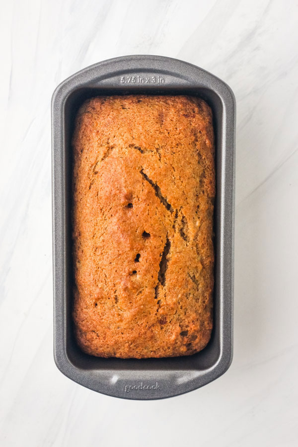 Overhead view of banana bread in a mini metal loaf pan.