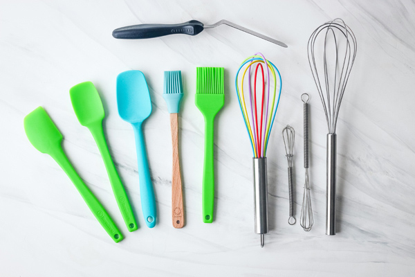 Mini rubber spatula, whisks, silicone brushes, and an offset spatula.