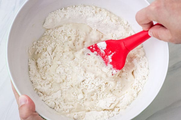 Handing stirring flour mixture in a bowl.