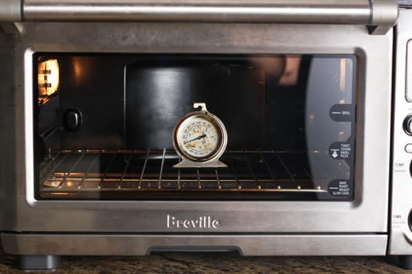 Small oven thermometer inside of a toaster oven.