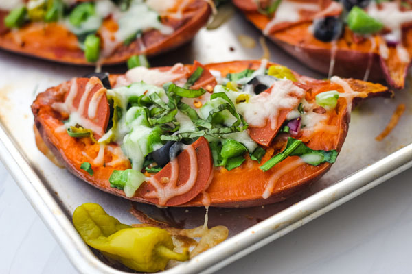 Baked sweet potatoes on a quarter sheet pan.