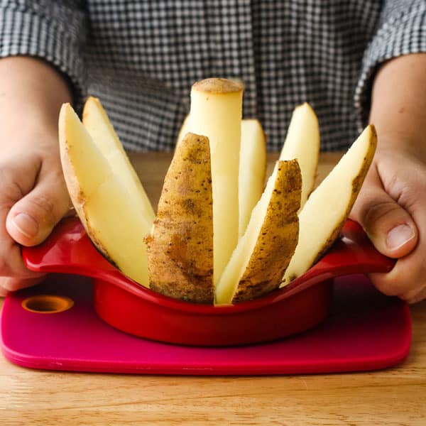 Potato sliced into wedges with an apple corer.