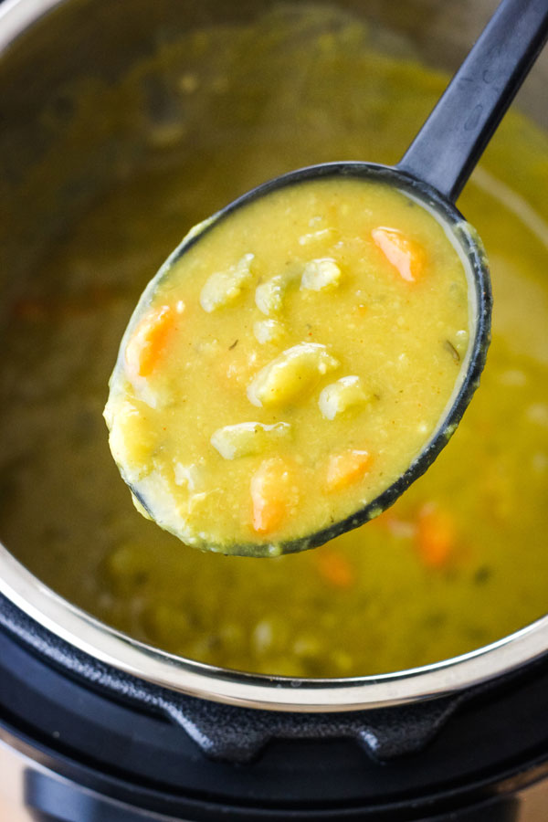 Spoon scooping soup out of an instant pot.