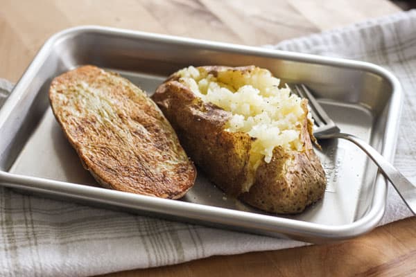 Large baked potato halves on a 1/8th baking sheet.