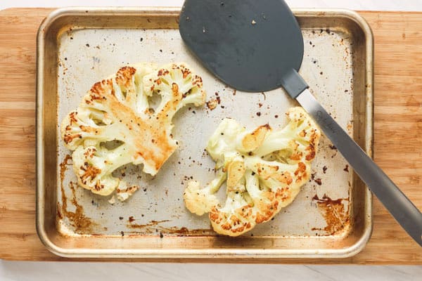 Golden roasted cauliflower on sheet pan.