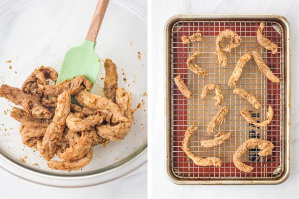 Seasoned curls arranged on a rack inside a sheet pan.