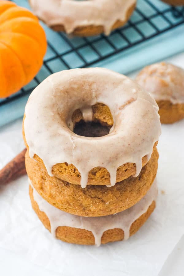 Stack of glazed pumpkin donuts.