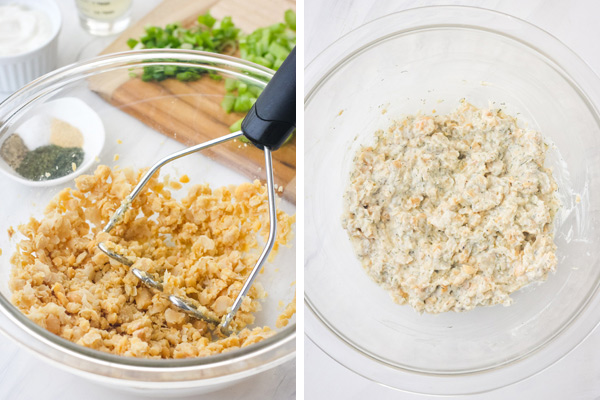 Bowl of smashed chickpeas and creamy salad mixture.