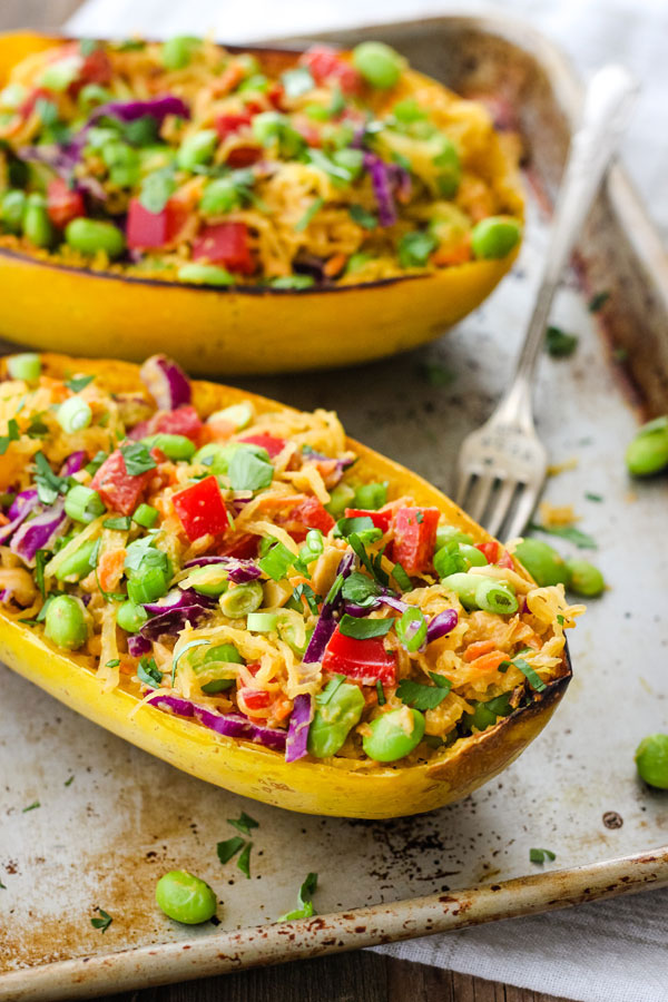 Stuffed spaghetti squash bowls on a metal sheet pan.