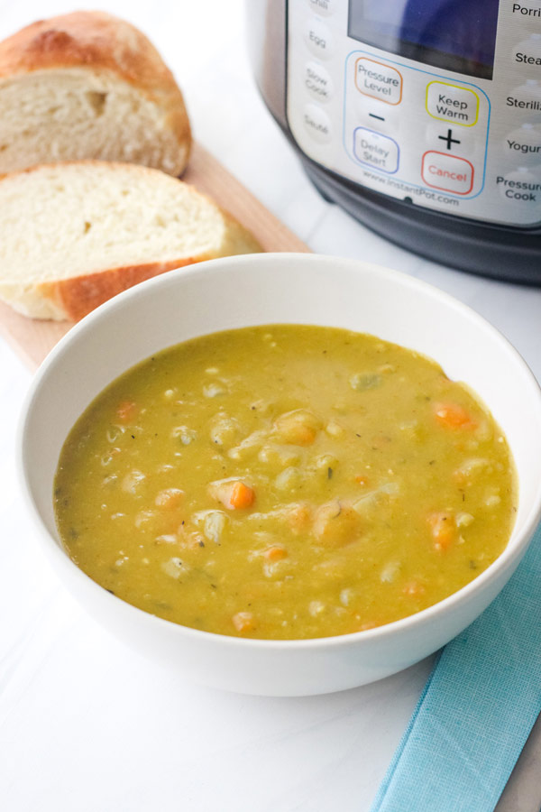 White bowl of soup in front of a 3-Quart Instant Pot.