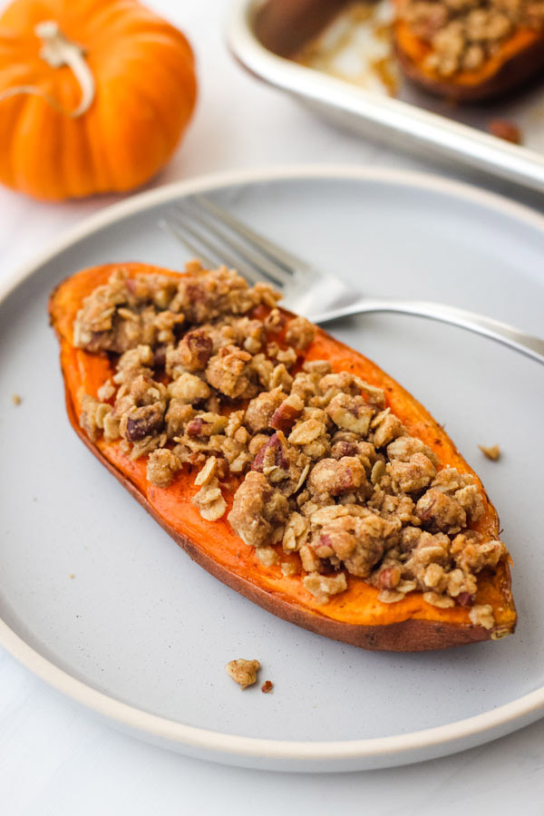 Twice baked sweet potato on a blue plate.