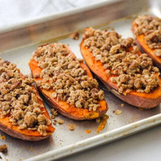 Baked sweet potatoes on a quarter sheet pan.