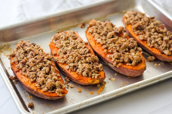 sweet potato halves on a quarter sheet pan.