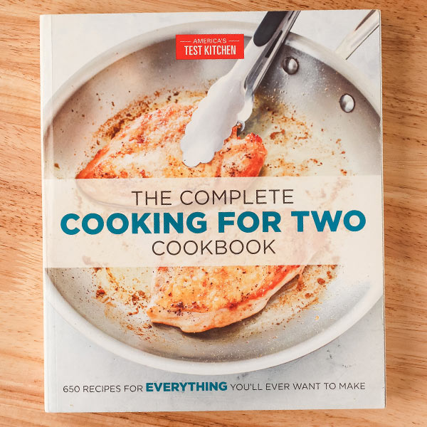 The Complete Cooking For Two Cookbook book cover with chicken breasts cooking in a skillet.