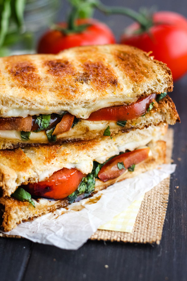 Toasted Caprese Sandwich on a piece of parchment.