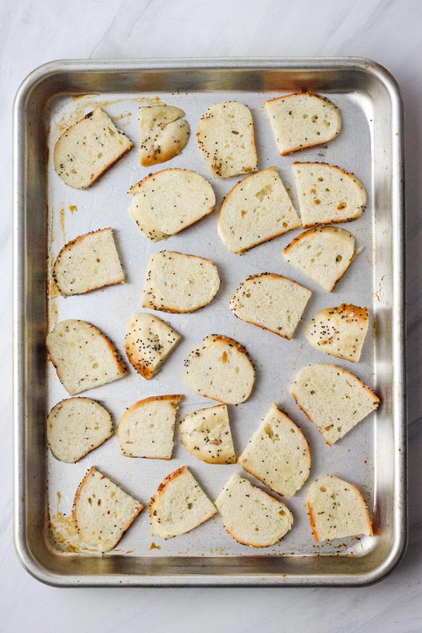 Bagel pieces on a quarter sheet pan.