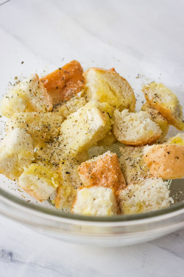 Cubed bread in a glass bowl.