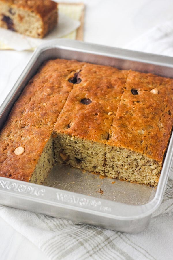 Baked banana bread in a small metal cake pan.