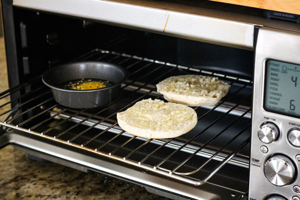A small baking pan and split English muffin inside a Breville Smart Oven Pro.