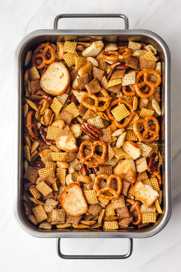 Toaster oven Chex mix in a small roasting pan.