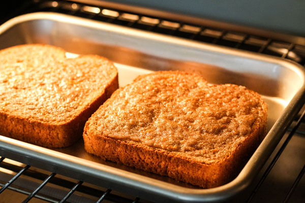 Sugar broiling on two slices of bread in a countertop oven.