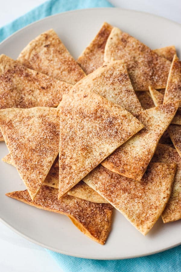 Cinnamon sugar chips on plate with blue napkin.