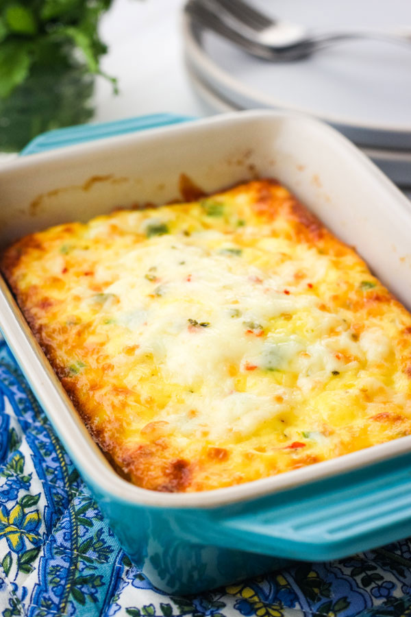 Cheesy egg bake in a small blue baking dish.