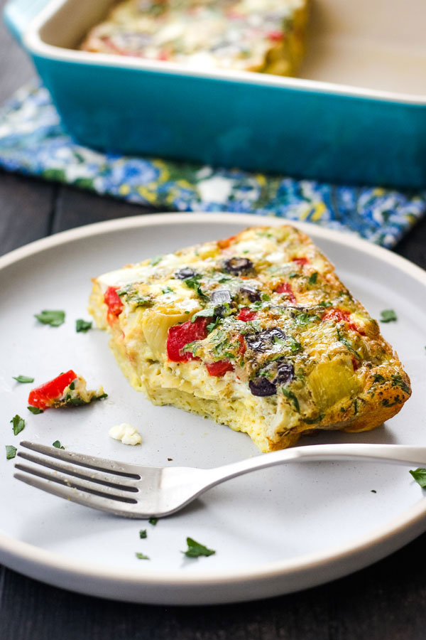 Baked frittata on a plate with a fork.