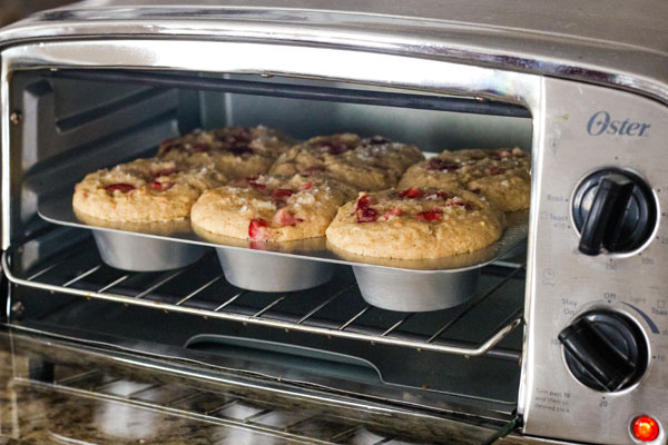 A pan of baked muffins inside a toaster oven.