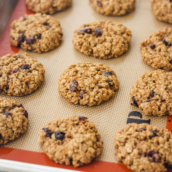 Baked oatmeal cookies on a silicone baking mat.