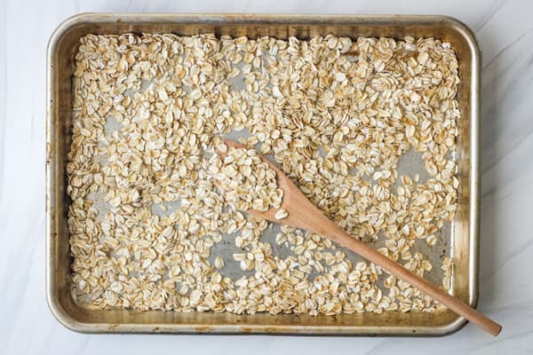 Toasted old fashioned oats in a rimmed sheet pan.