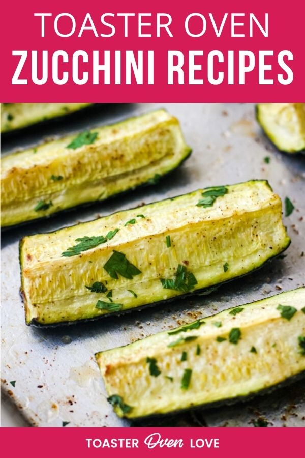 Roasted zucchini wedges topped with chopped parsley on a baking sheet.