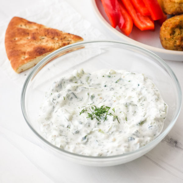 Small batch tzatziki sauce in a glass bowl.